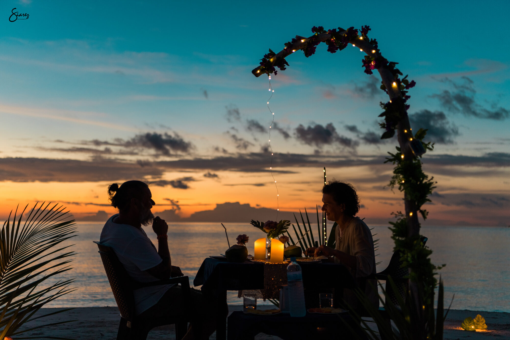 Romantic sunset beach dinner setup